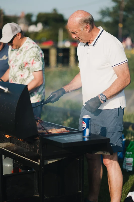 a man grilling a burger on a barbeque