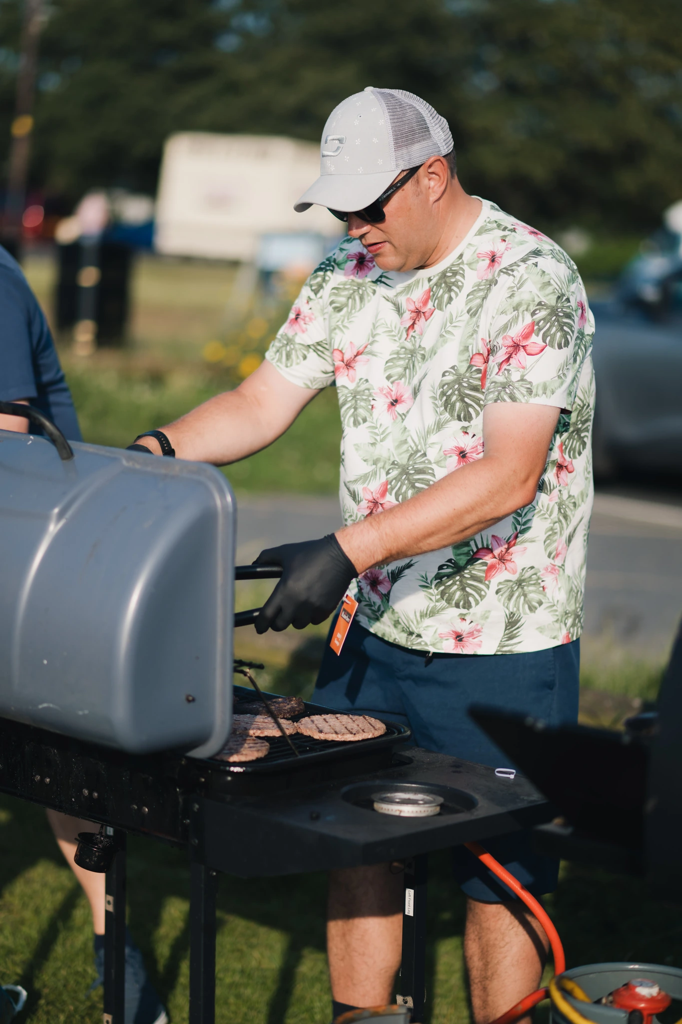 a man grilling a burger on a barbecue grill