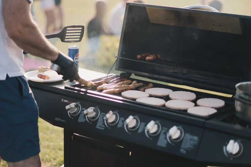 a man is cooking food on a bbq grill