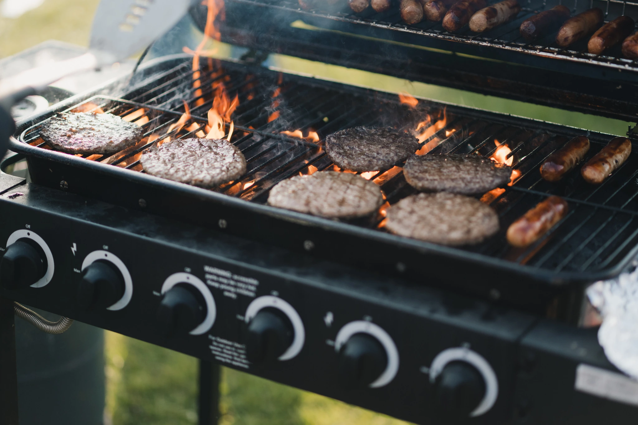 burgers and hotdogs on a grill