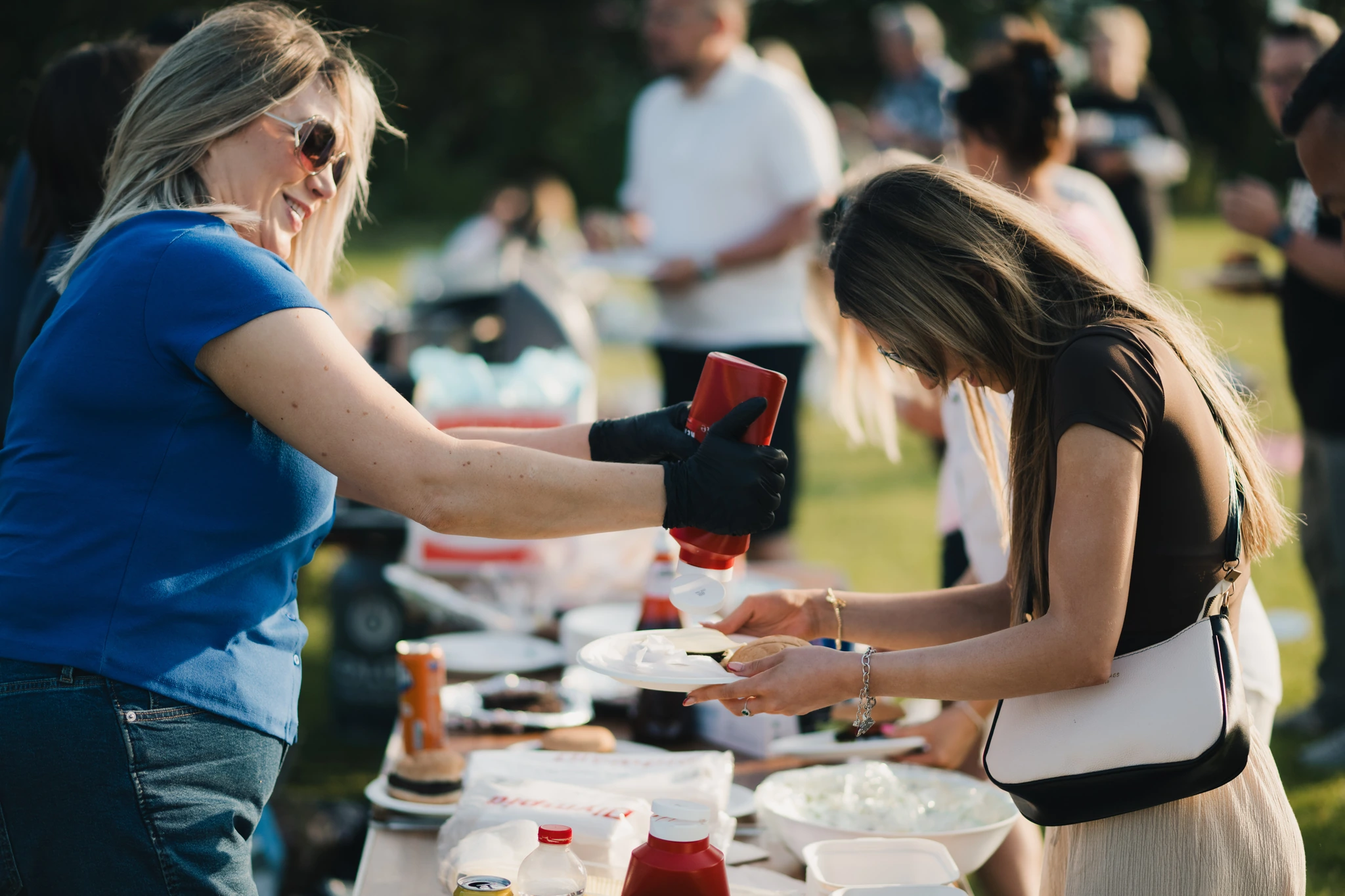 a woman is pouring sauce on a plate of food