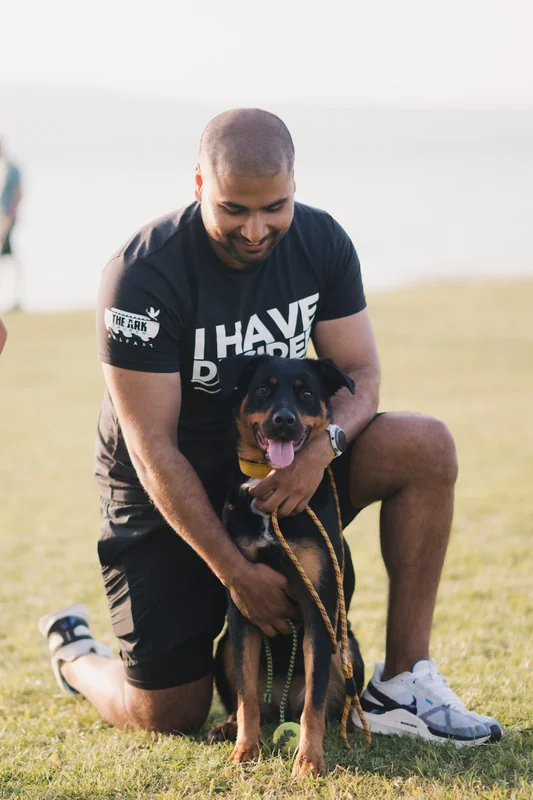 a man with a dog on a leash in a park