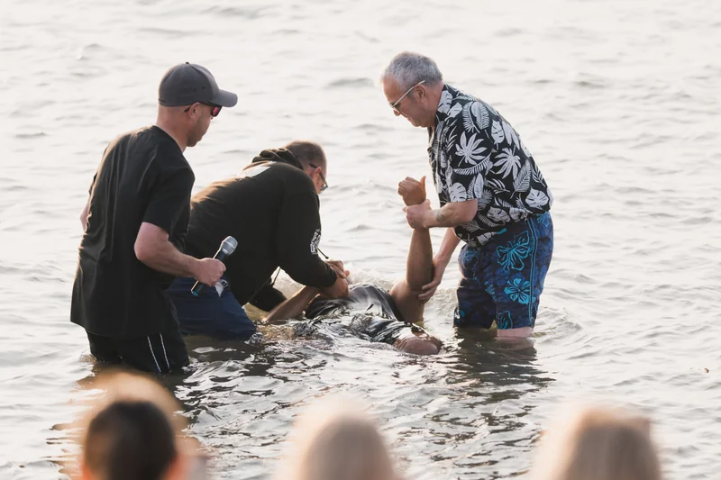 a man is being baptized in the water