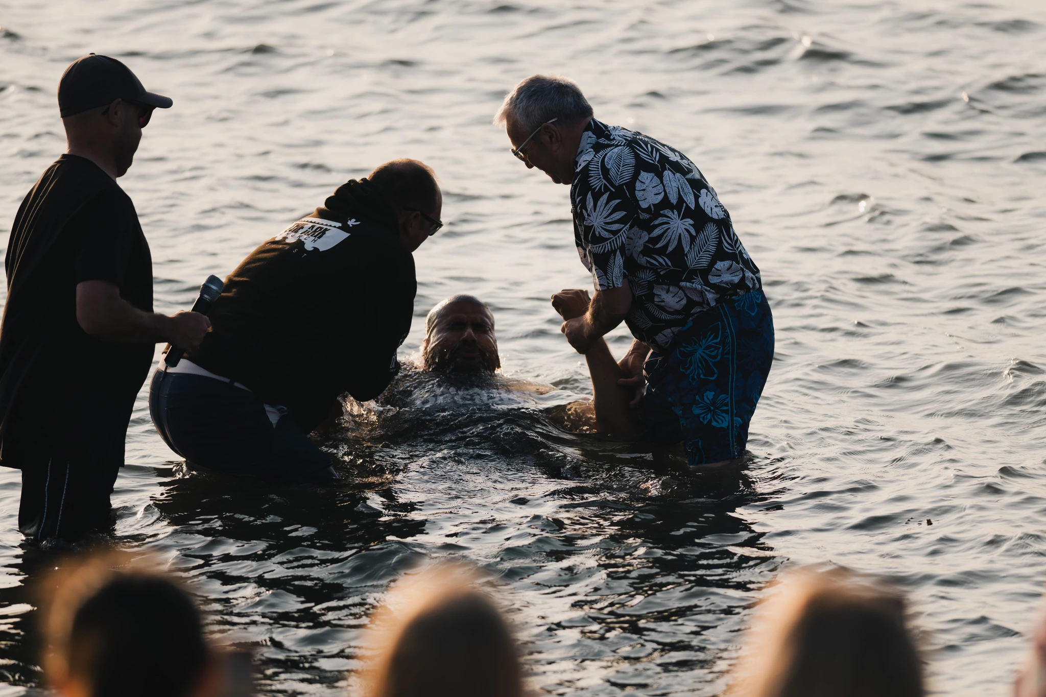 a man is being baptized by a woman in the water