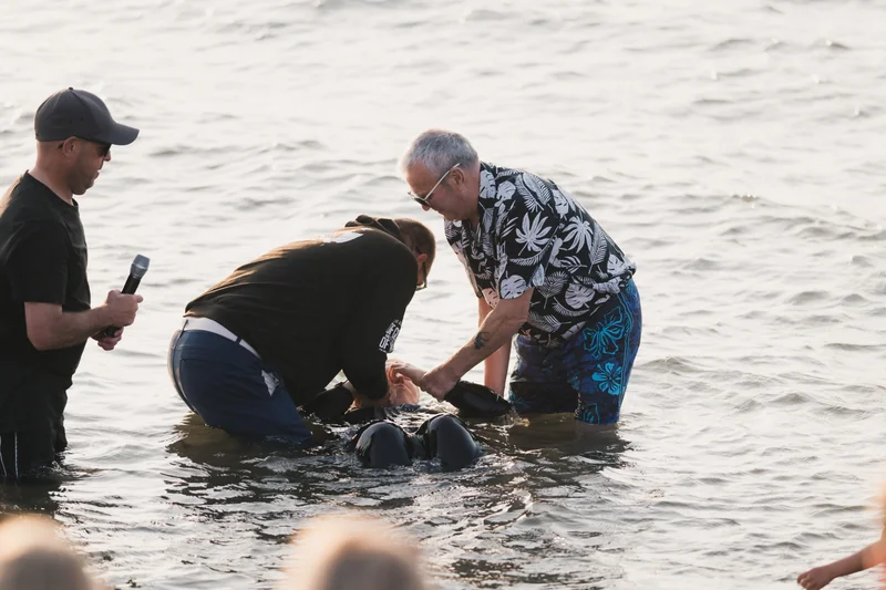 a man in a bathing position with a woman in the water