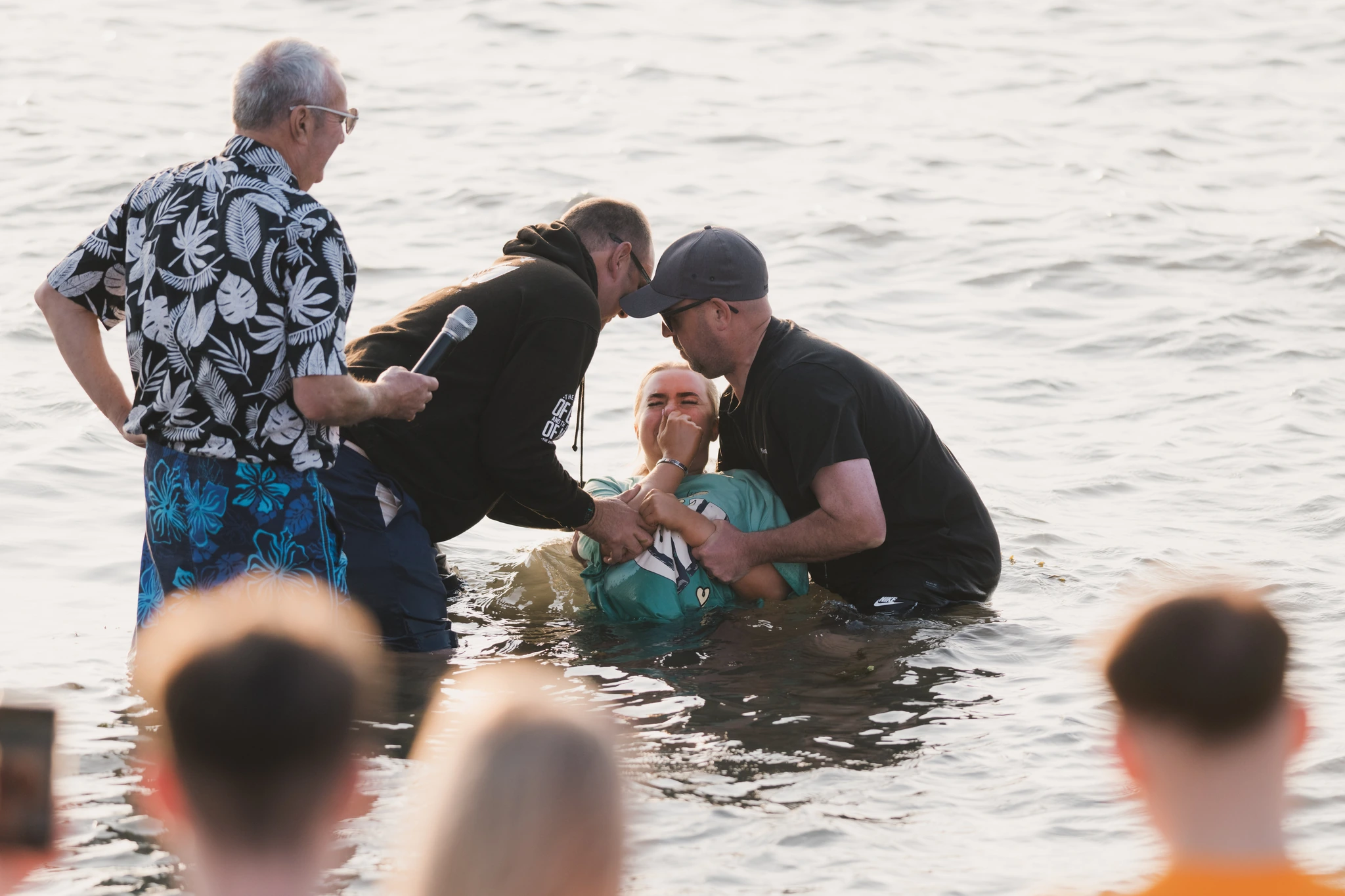 a man in the water with a woman in the background