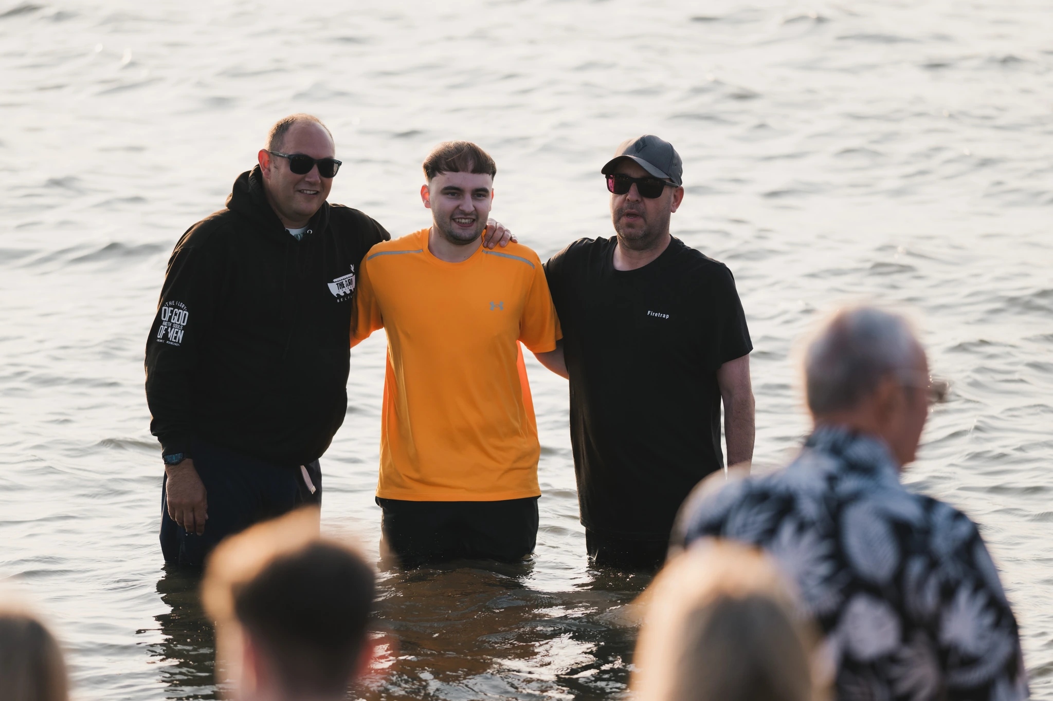 a group of men and women standing in the middle of a crowd of people