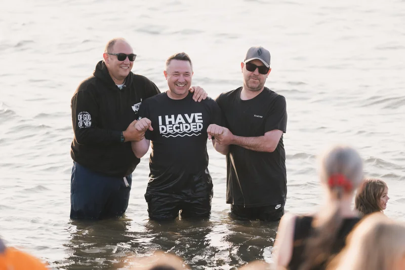 a man is standing in the water with a group of people