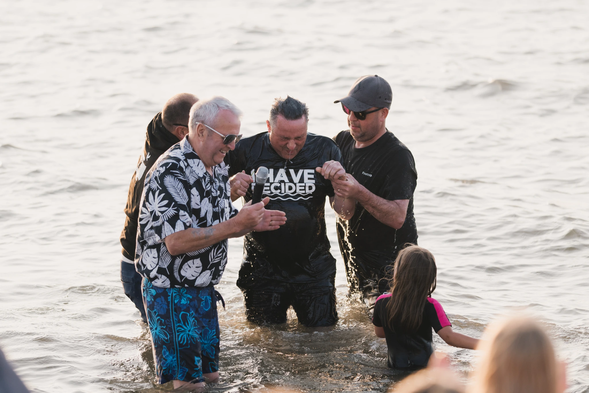 a group of people standing in the water