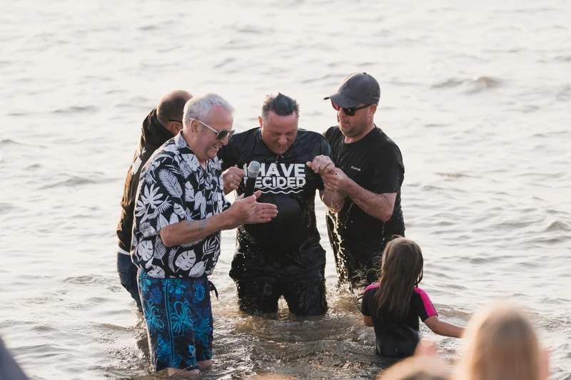 a group of people standing in the water