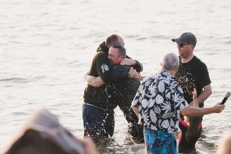 a group of people hugging in the water