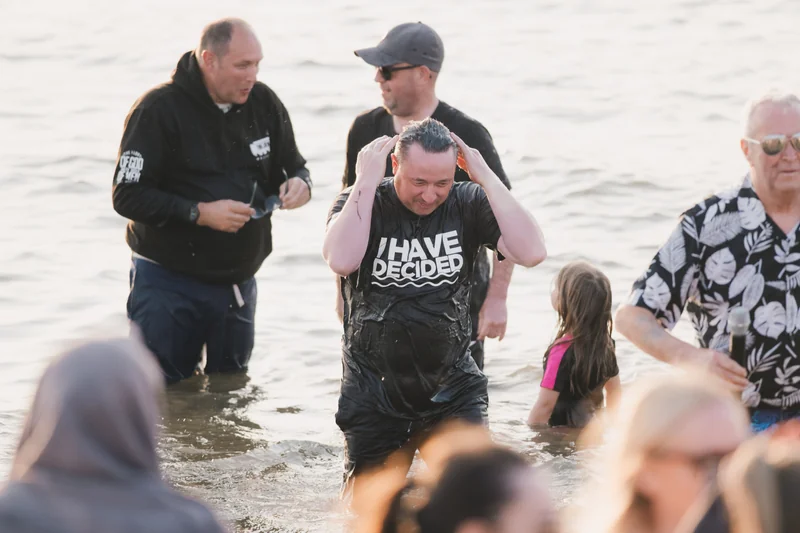 a group of people standing in the water