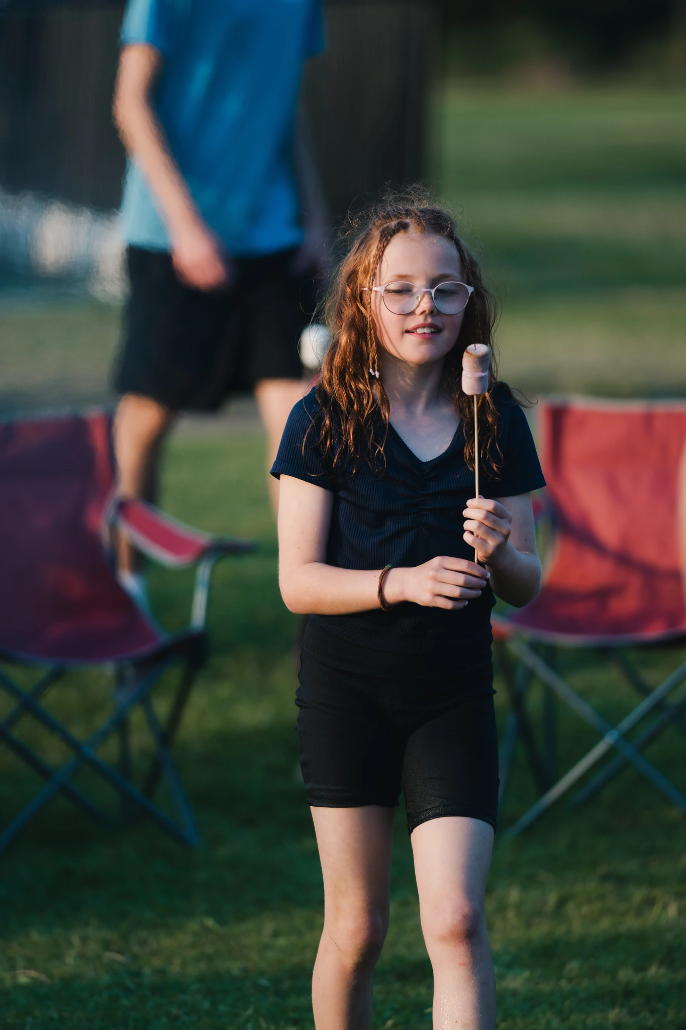 a girl holds a baton in a grassy field