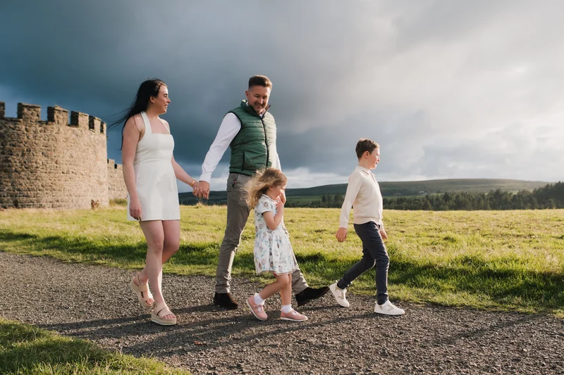 a family in front of a castle