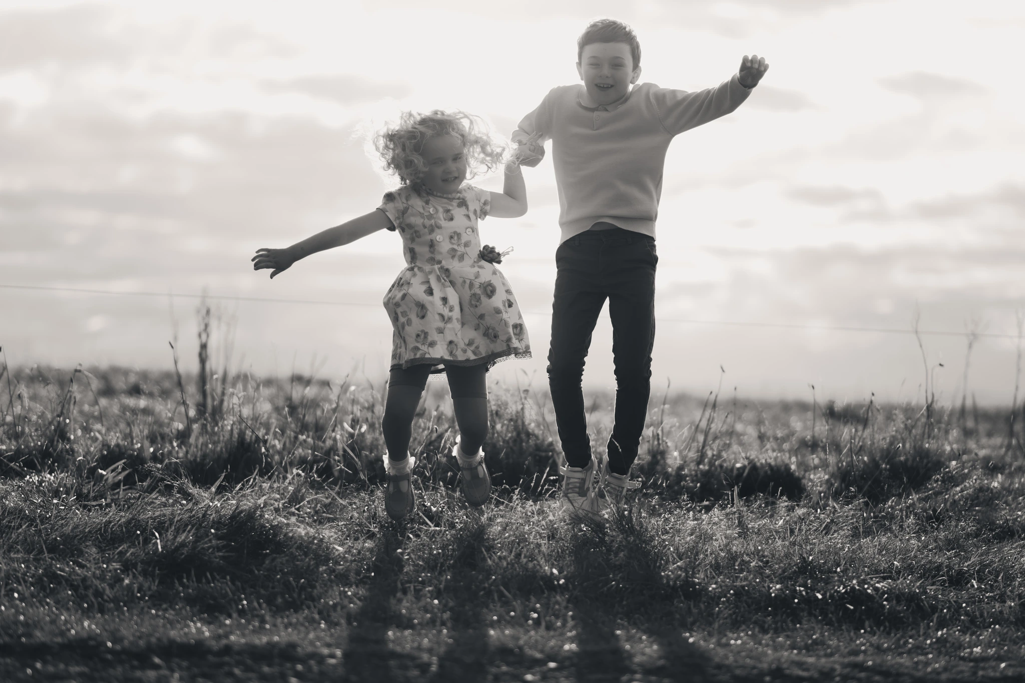 a father and daughter playing in a field