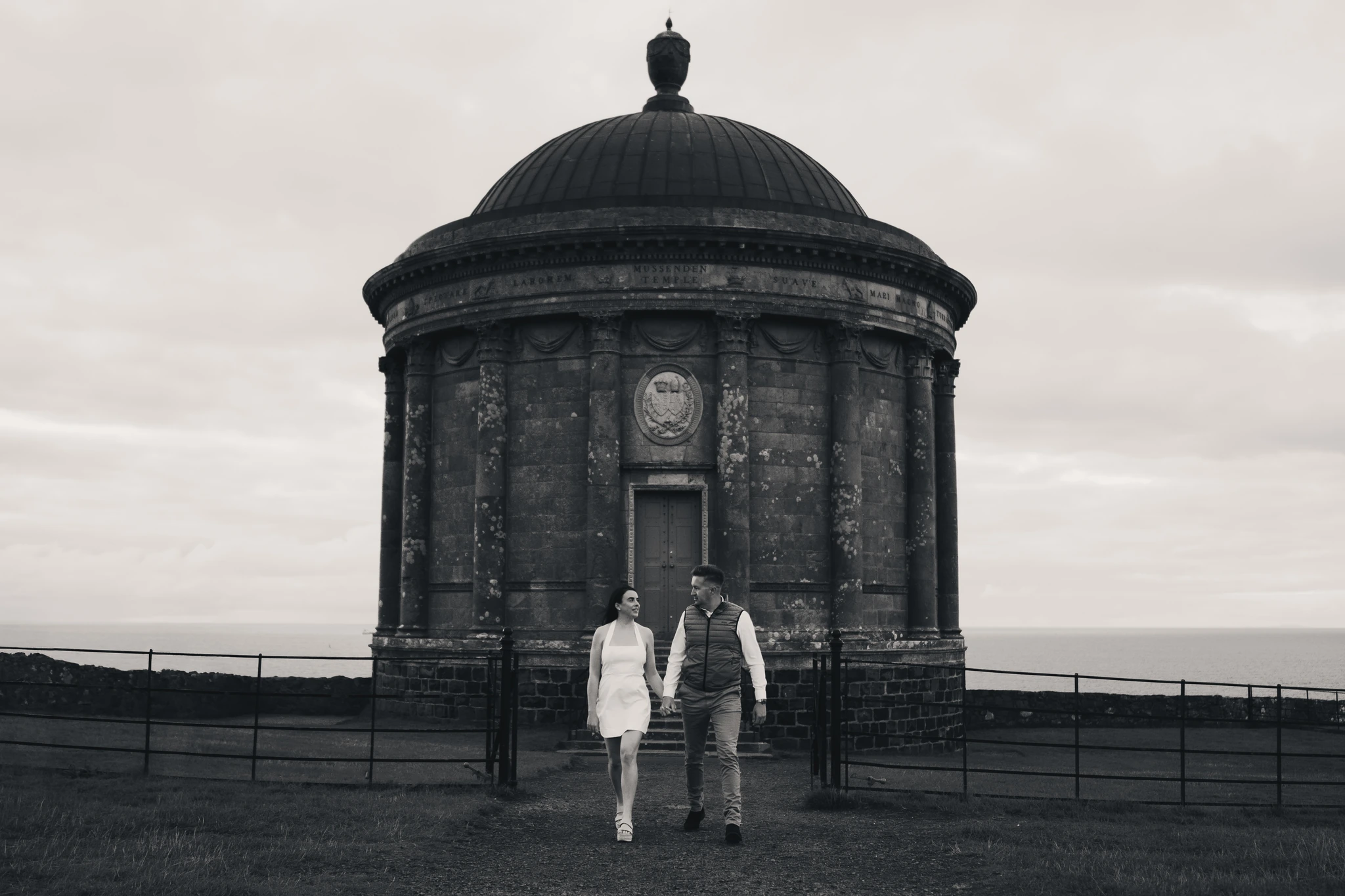 a bride and groom standing in front of a building