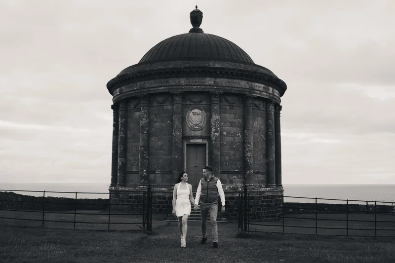 a bride and groom standing in front of a building