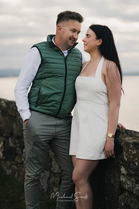 a bride and groom pose for an engagement photo shoot in ireland
