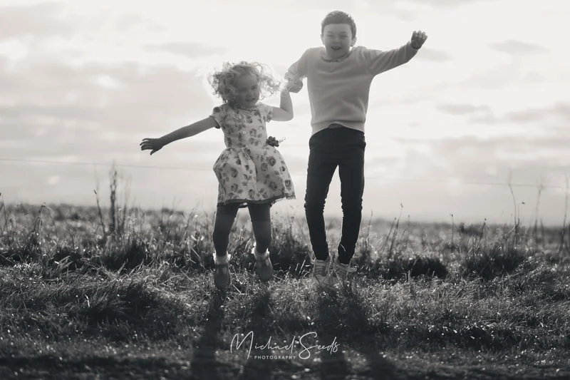 a father and daughter playing in a field
