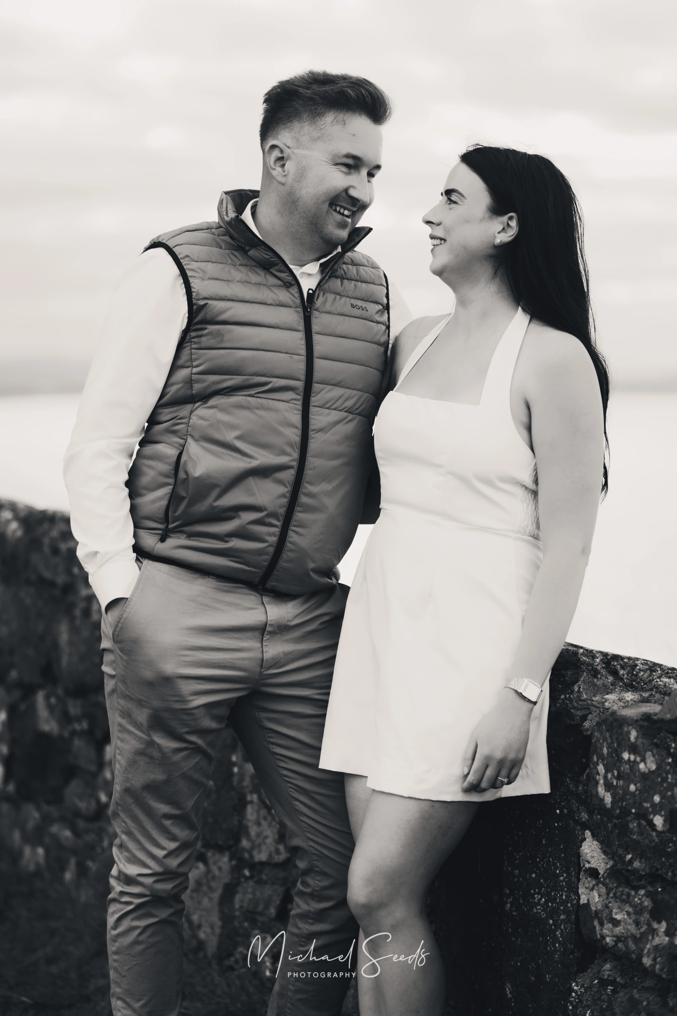 a bride and groom pose for an engagement photo shoot in ireland
