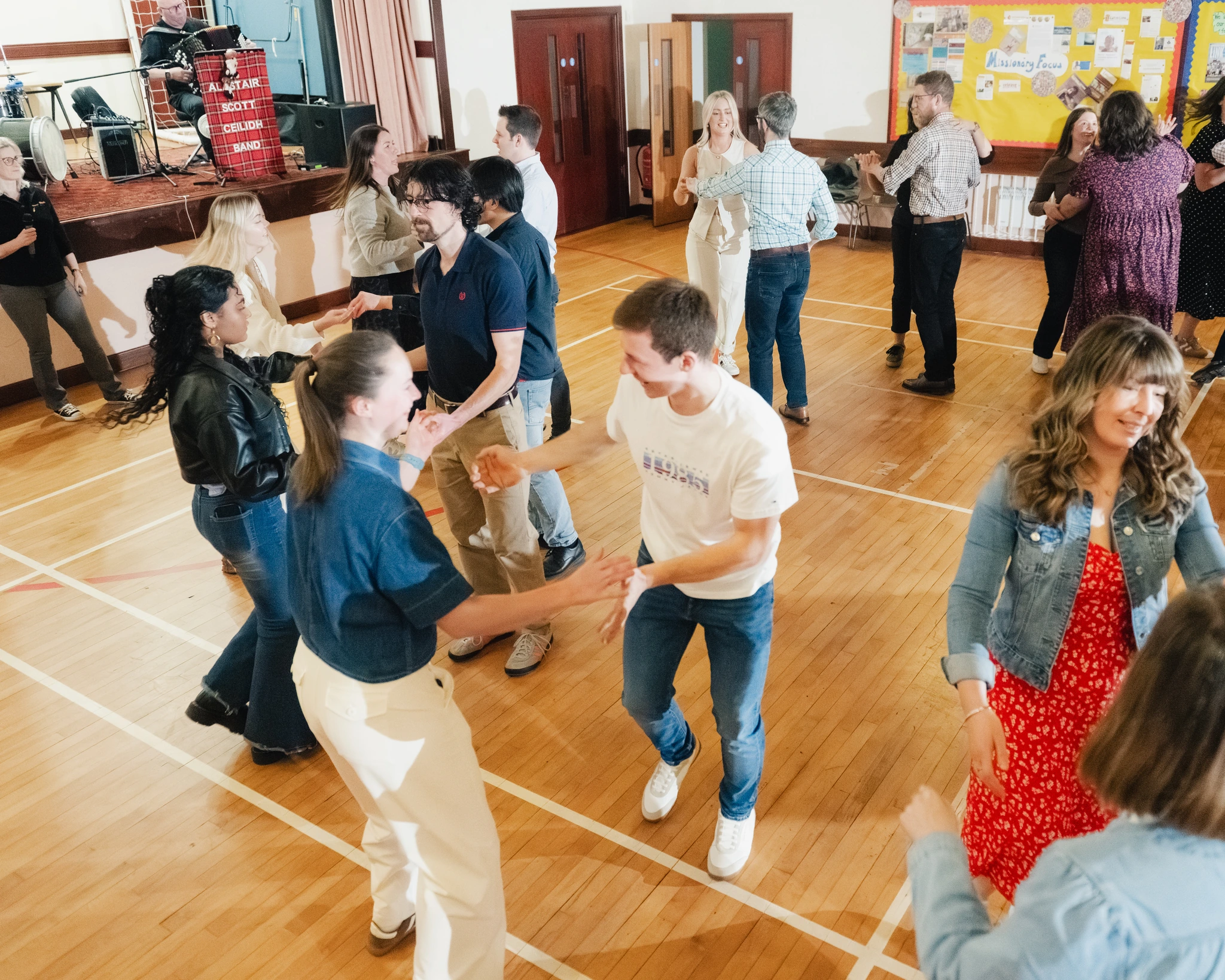 a group of people dancing in a hall
