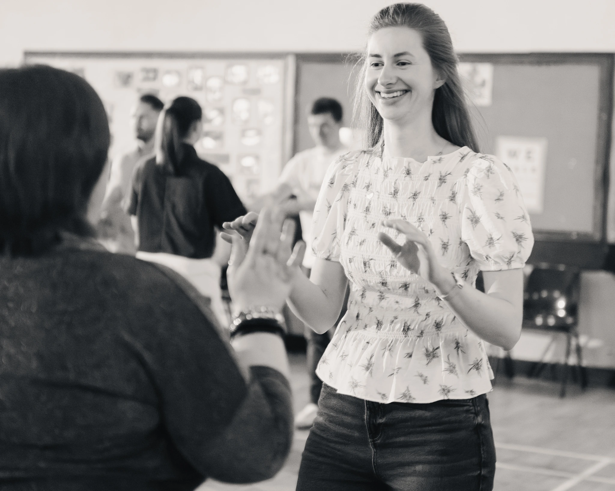 black and white photograph of a woman dancing in a classroom