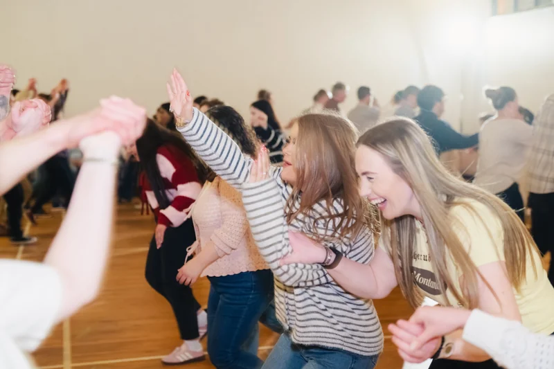 a group of people dancing in a dance floor