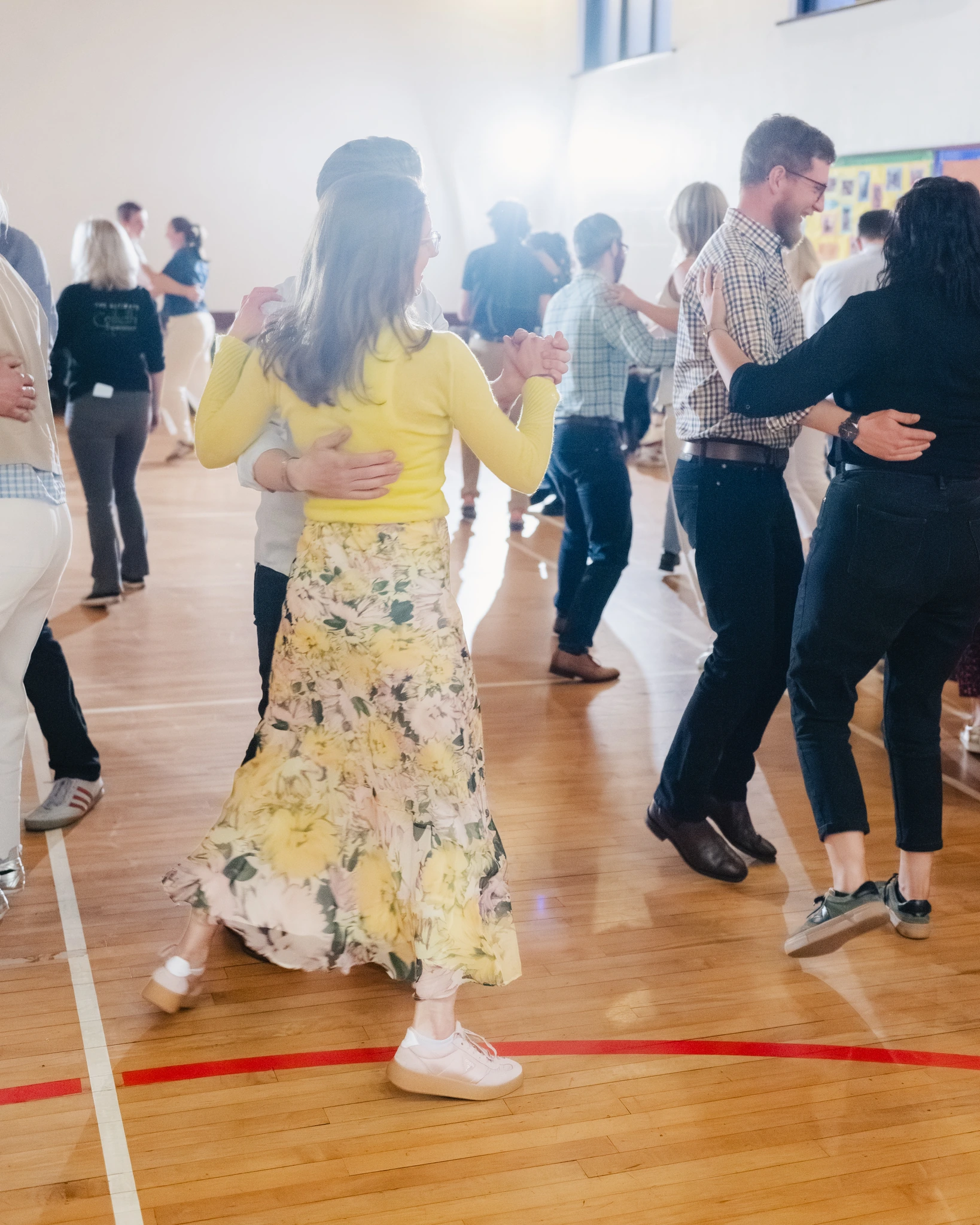 a group of people dancing in a gymnasium