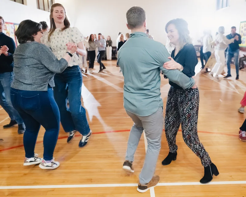 a group of people dancing in a gymnasium