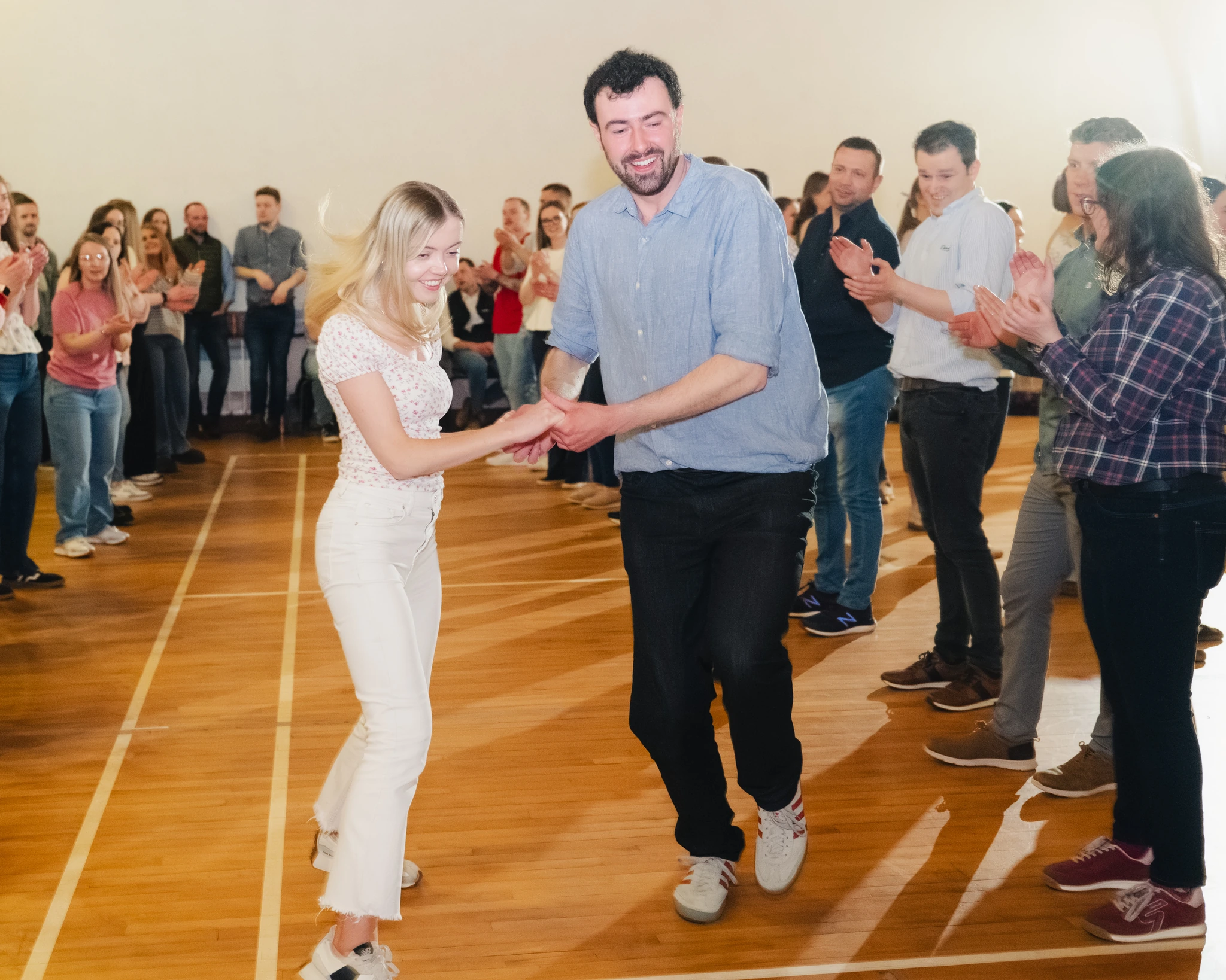 a man and woman dancing on a dance floor in front of a crowd of people