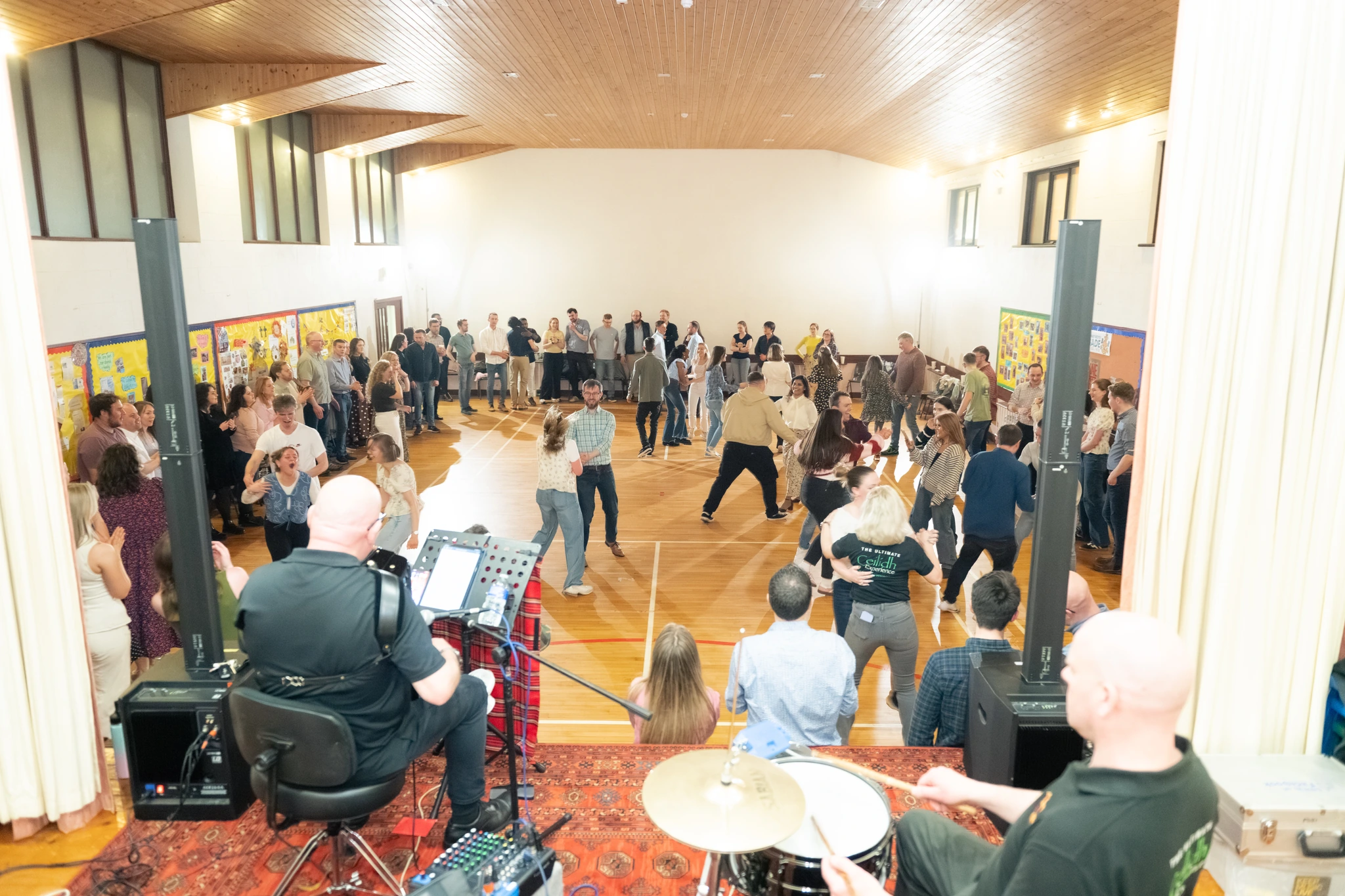 a group of people standing in a large room