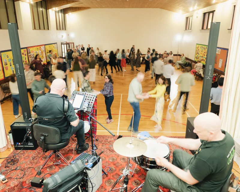 a group of people playing drums in a room