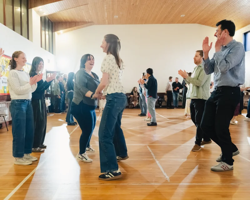 a group of people dancing in a room
