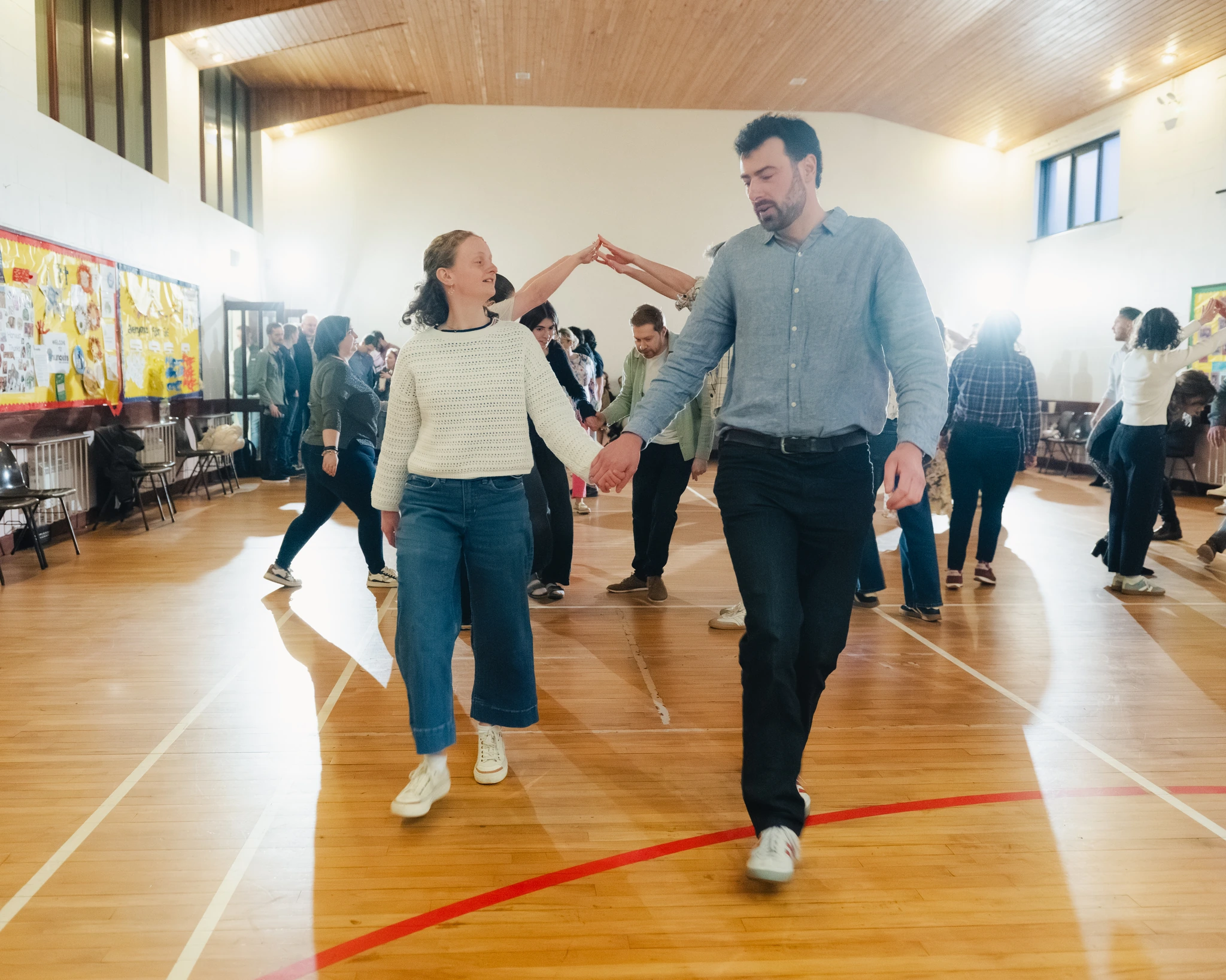 a man and woman dancing in a gymnasium