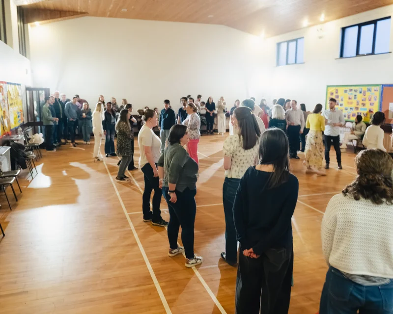 a large group of people standing in a room