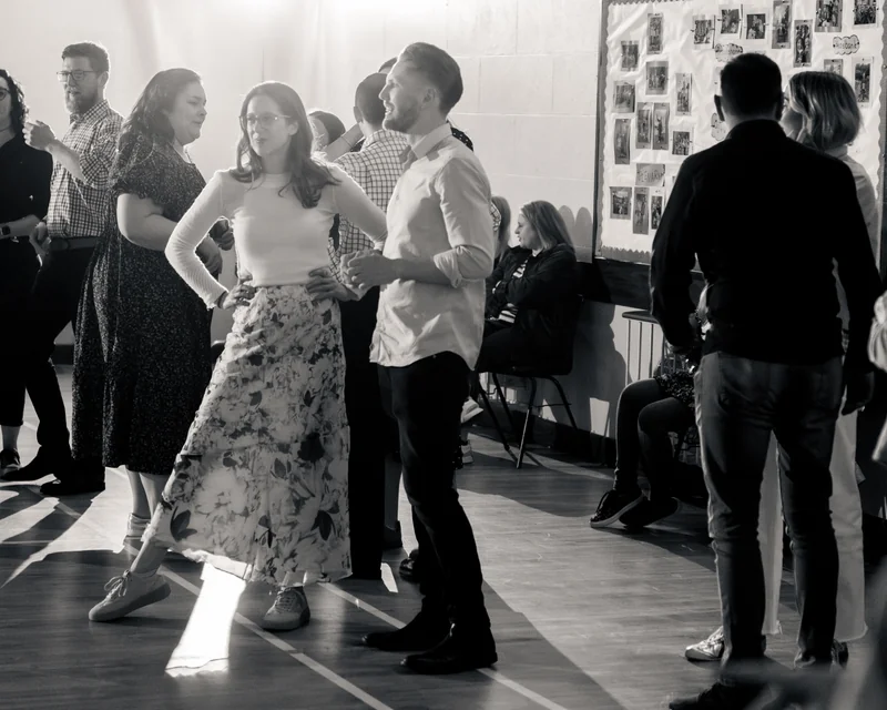 a group of people dancing in a room