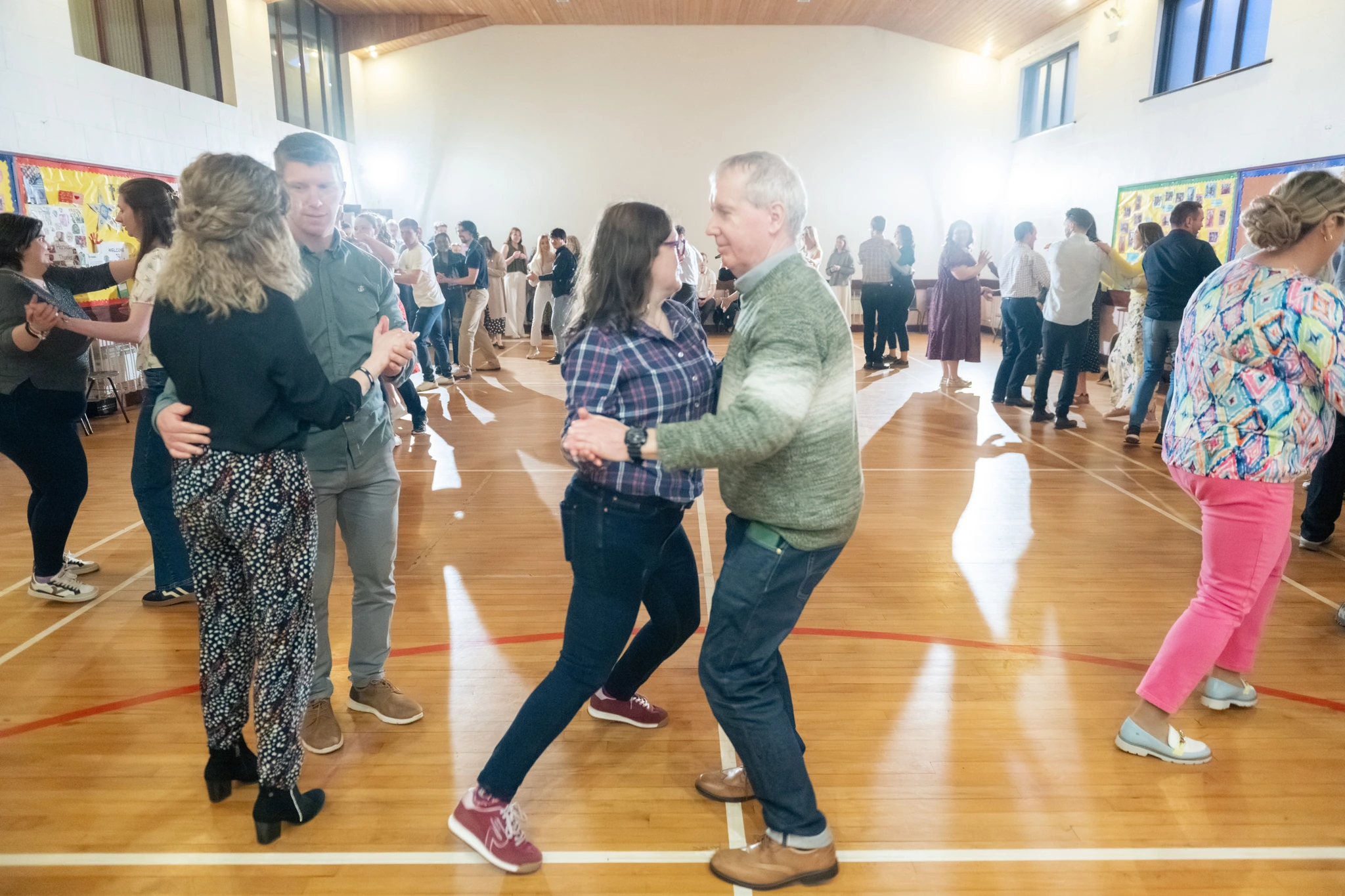 a group of people dancing in a gymnasium