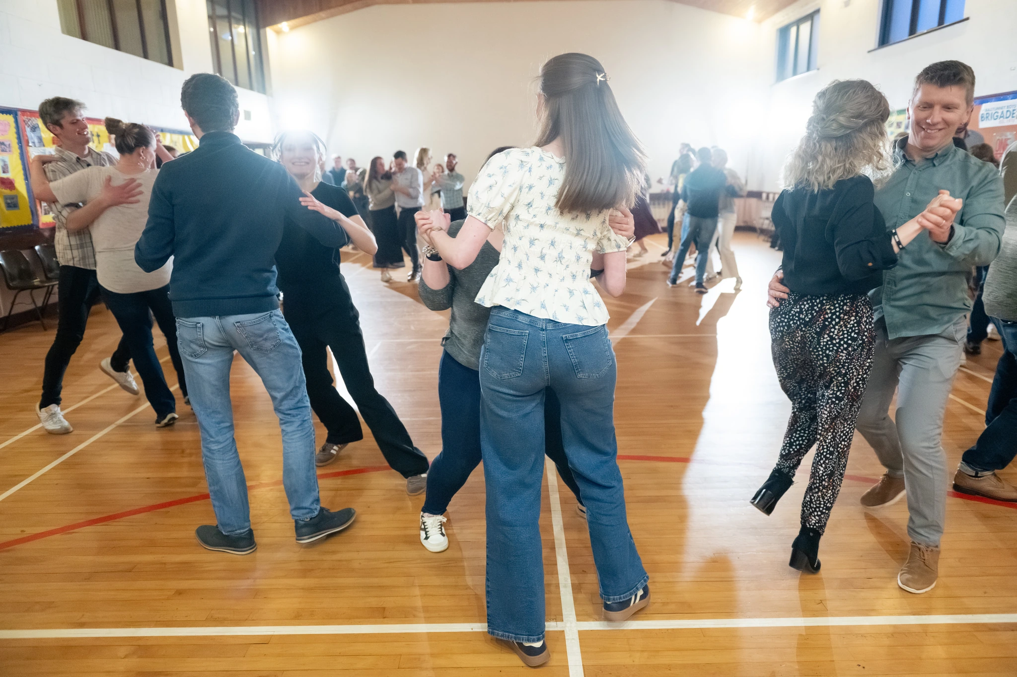 a group of people dancing in a gymnasium