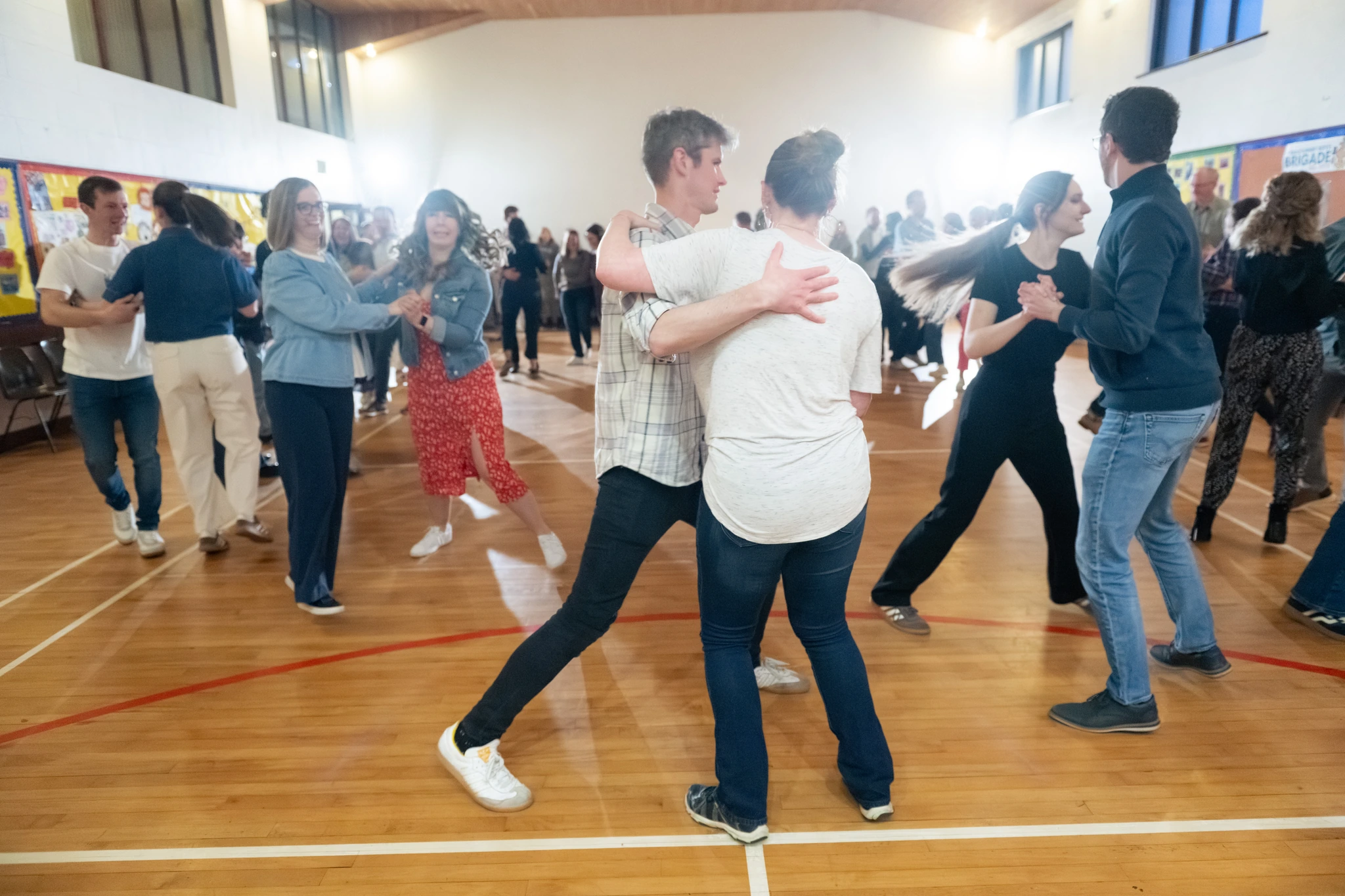 a group of people dancing in a gymnasium