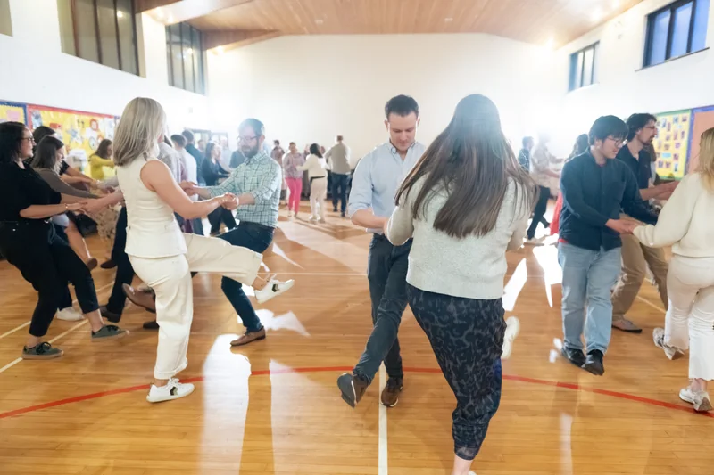 a group of people dancing in a gymnasium