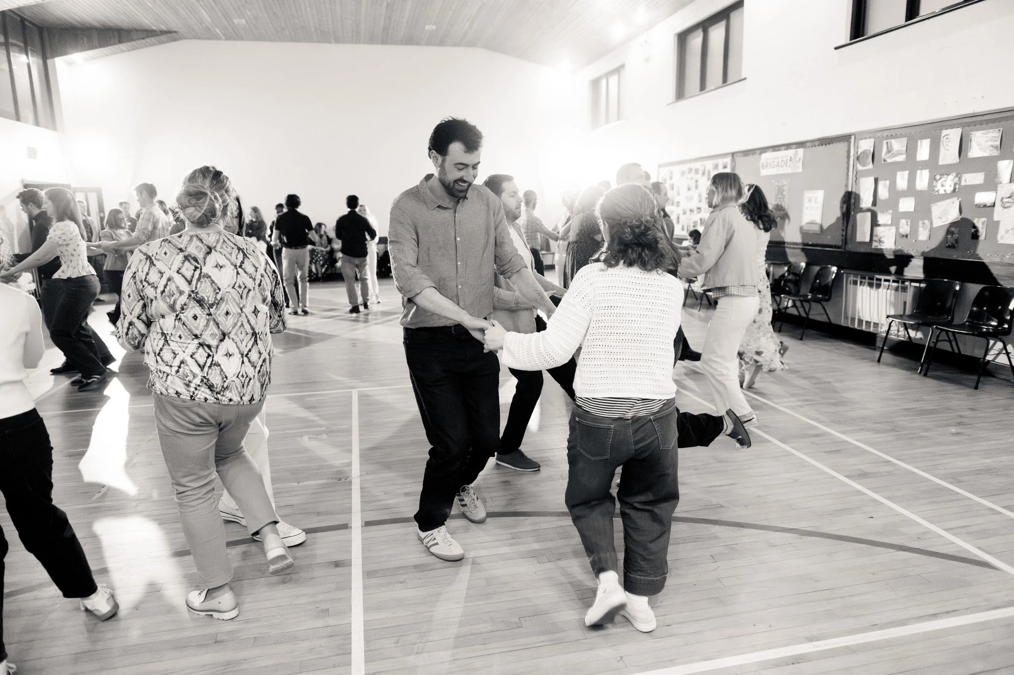 a group of people dancing in a gymnasium