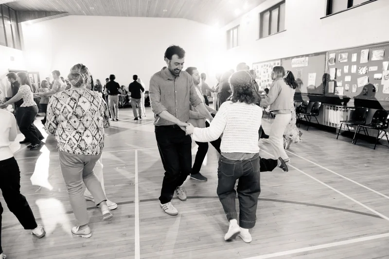 a group of people dancing in a gymnasium