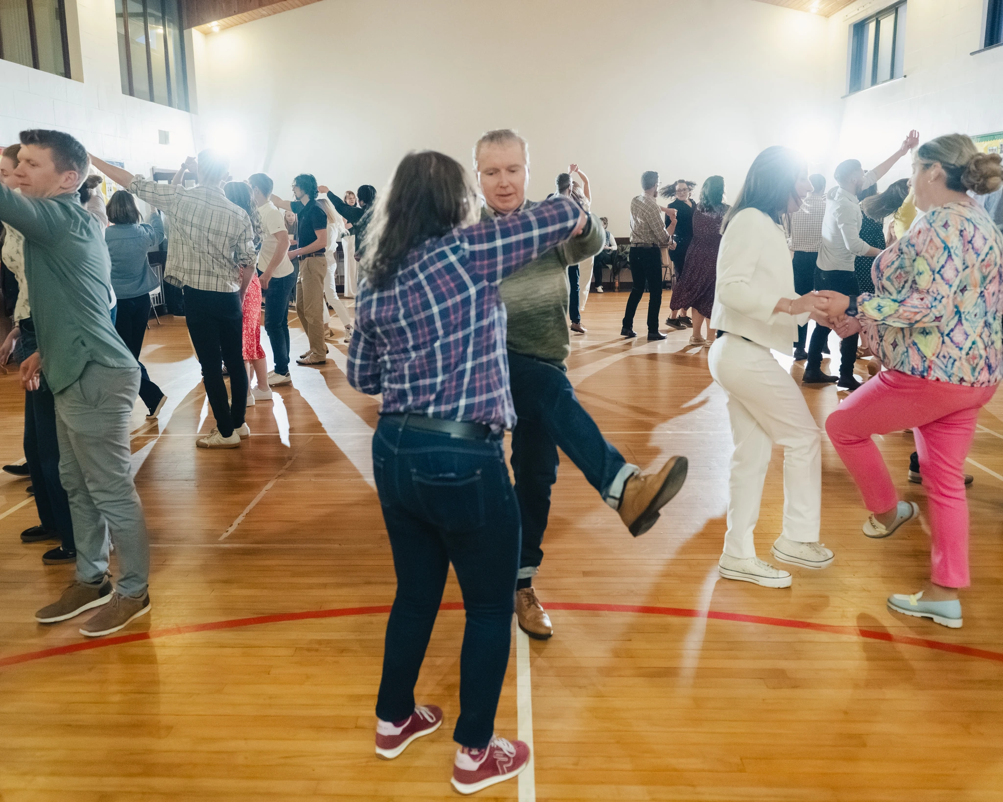 a group of people dancing in a gymnasium