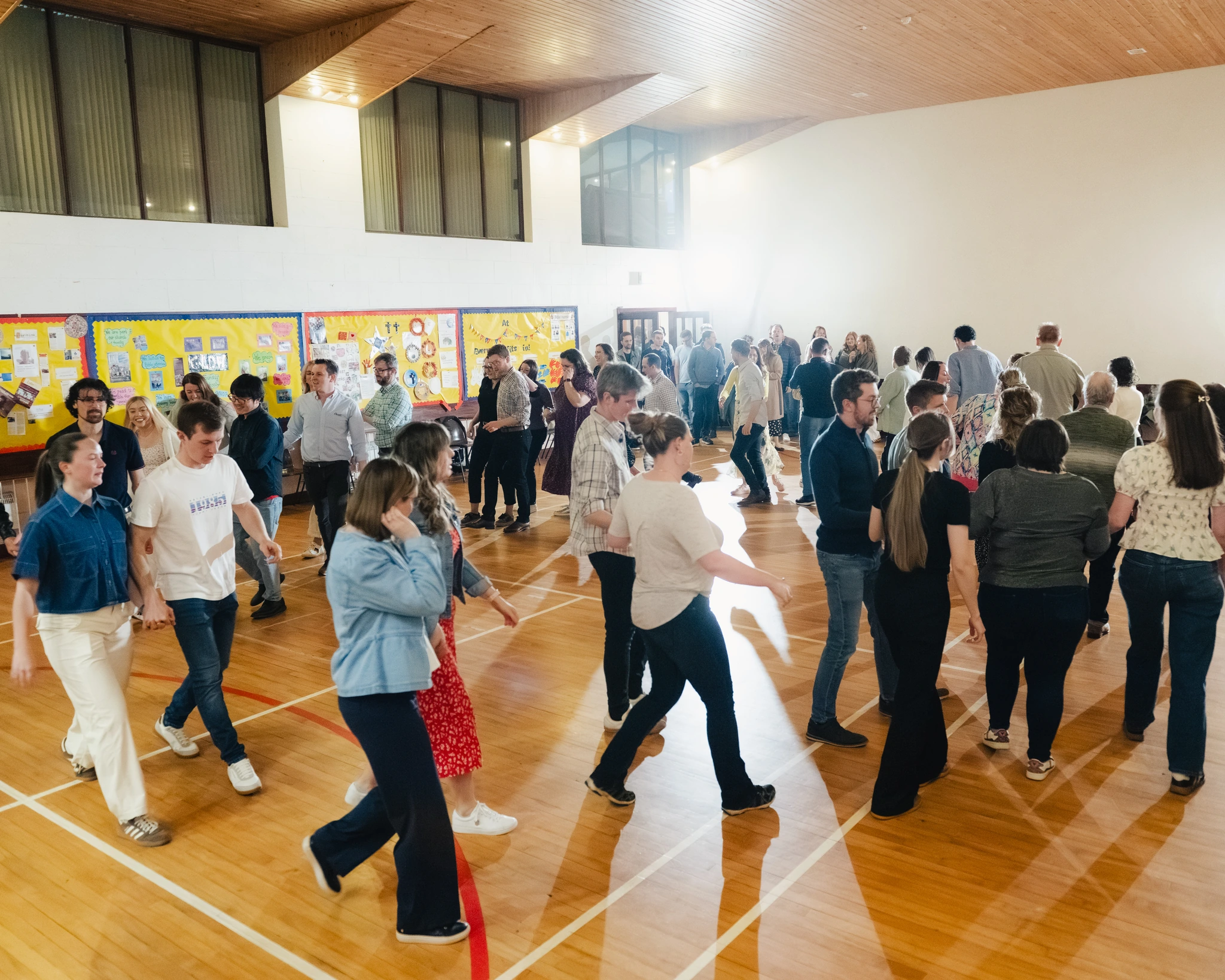 a group of people dancing in a gymnasium