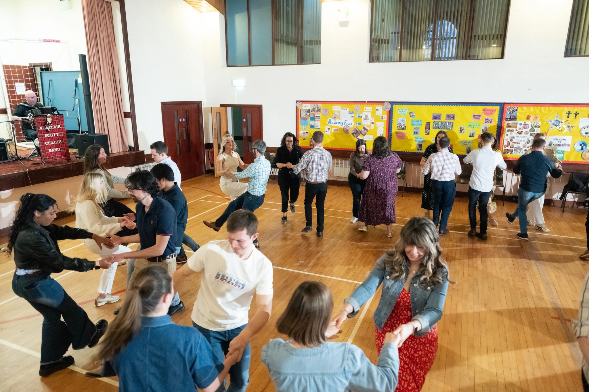 a group of people dancing in a hall