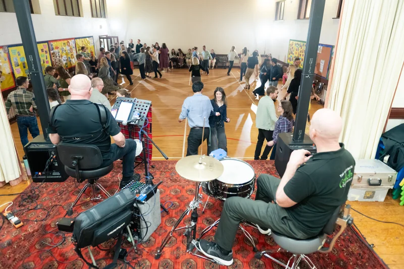 a group of people playing instruments in a room