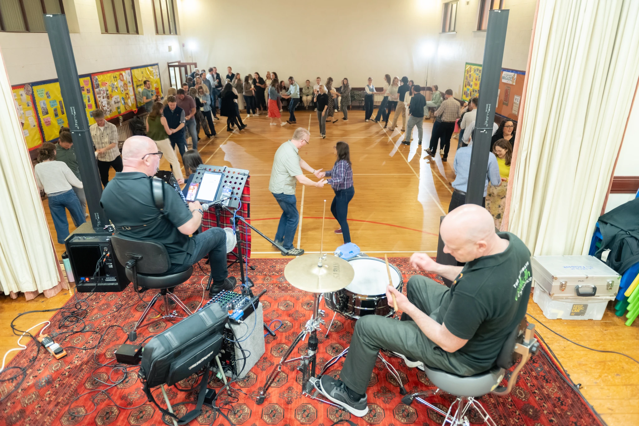a group of people playing instruments in a gymnasium
