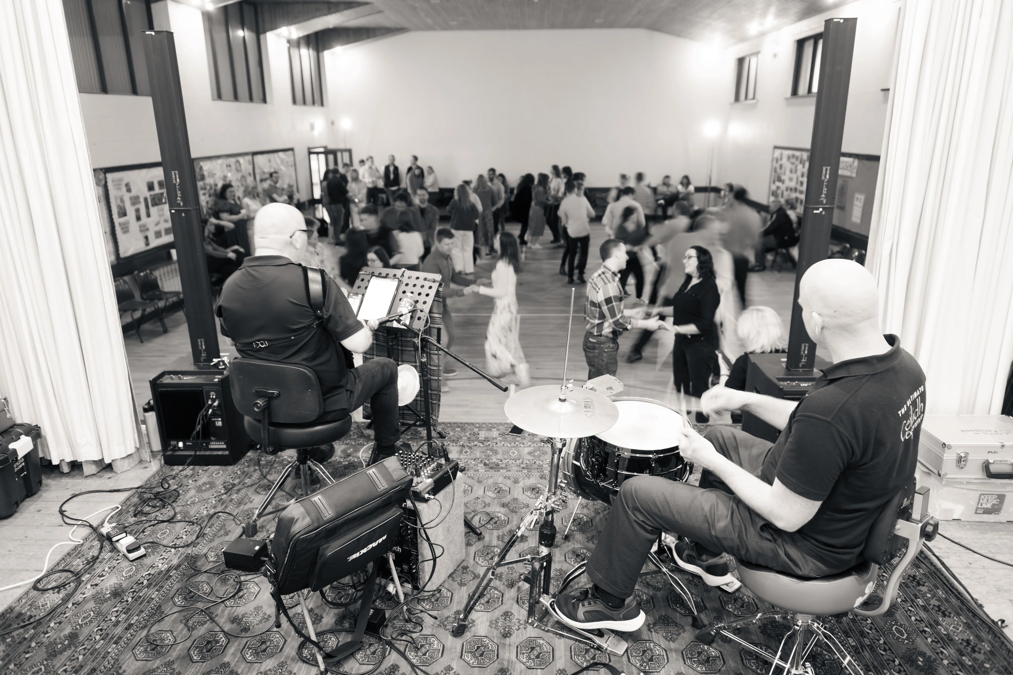black and white photograph of a band playing music in a room