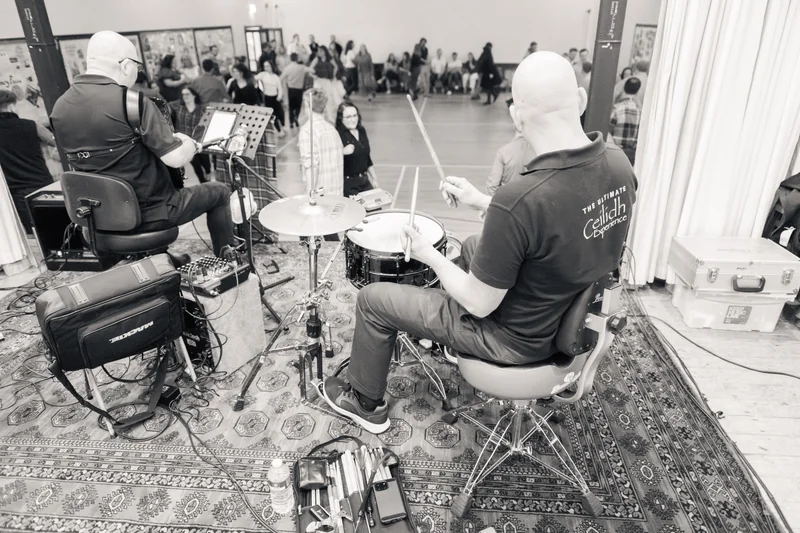 a group of musicians playing drums in a room