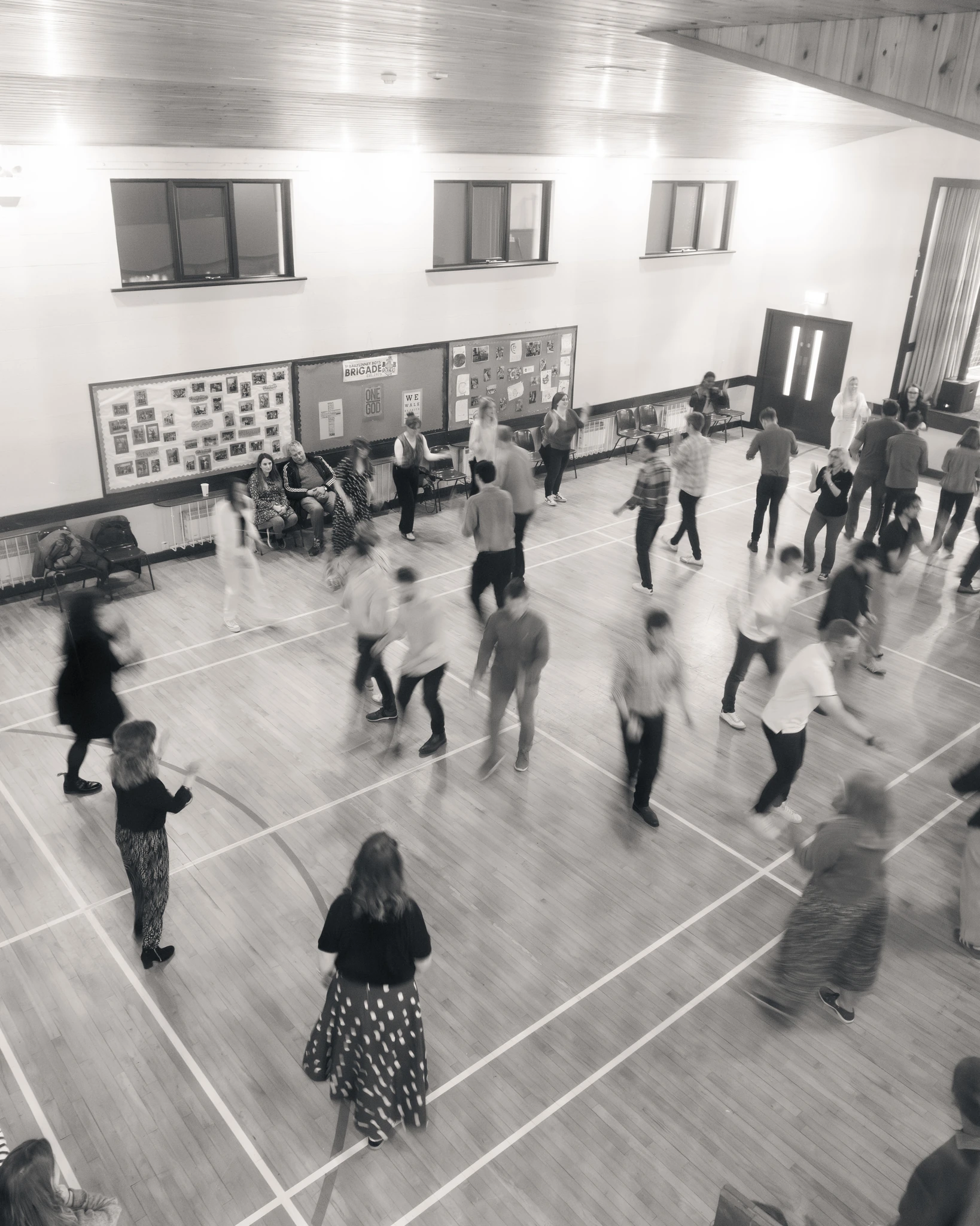 a group of people dancing in a gymnasium